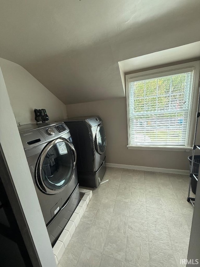 laundry area featuring washing machine and dryer and baseboards