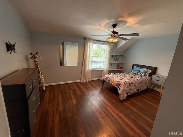 bedroom featuring dark wood-type flooring, baseboards, a ceiling fan, and vaulted ceiling