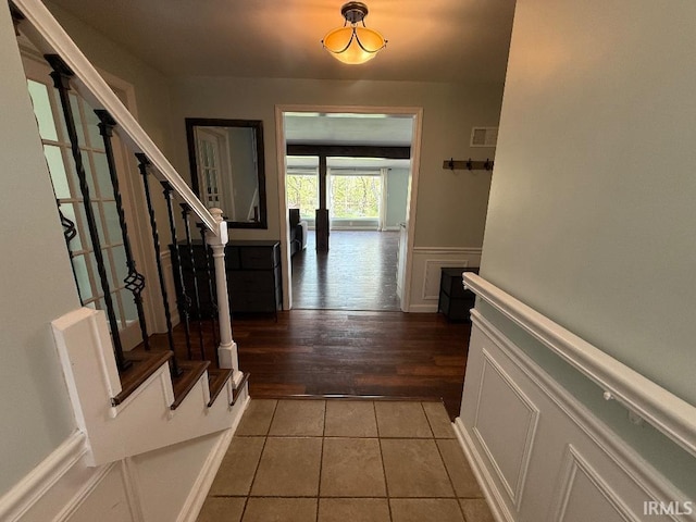 foyer entrance featuring stairway and light tile patterned flooring