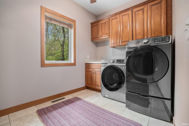 51205 County Road 25th Rd, Bristol, IN 46507 - laundry area featuring cabinet space, baseboards, light tile patterned flooring, and washer and dryer