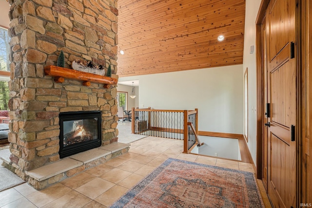 51205 County Road 25th Rd, Bristol, IN 46507 - unfurnished living room with tile patterned floors, a towering ceiling, and a stone fireplace
