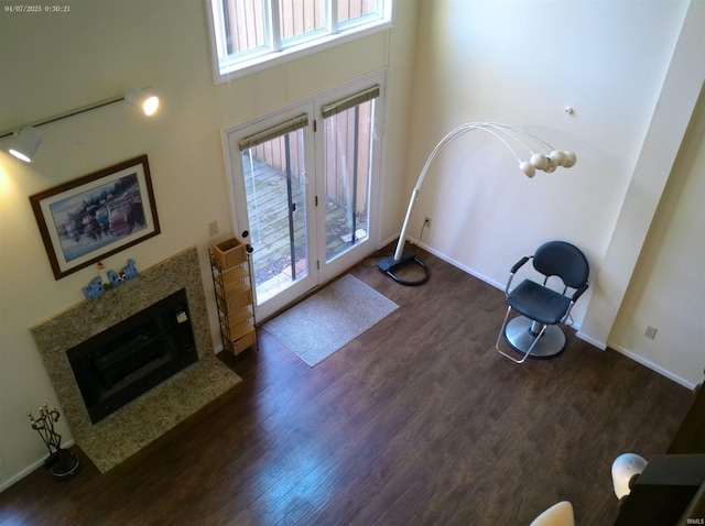 4068 E Eagle Bay Dr Unit 46, Bloomington, IN 47401 - entryway with dark wood finished floors, a towering ceiling, a fireplace, and baseboards