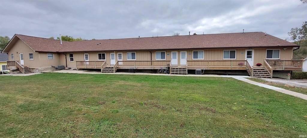 800 W 11th St, Bloomington, IN 47404 - rear view of house with a lawn, central AC unit, a deck, and roof with shingles