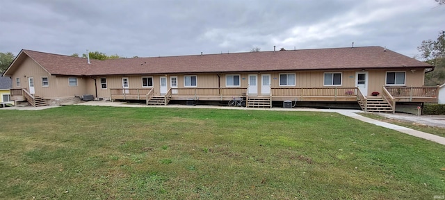 800 W 11th St, Bloomington, IN 47404 - rear view of house with a lawn, central AC unit, a deck, and roof with shingles