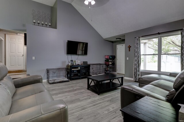 4732 Rathbone Dr, Evansville, IN 47725 - living room with high vaulted ceiling, baseboards, a ceiling fan, and light wood-style flooring