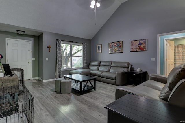 4732 Rathbone Dr, Evansville, IN 47725 - living area featuring wood finished floors, a ceiling fan, high vaulted ceiling, and baseboards