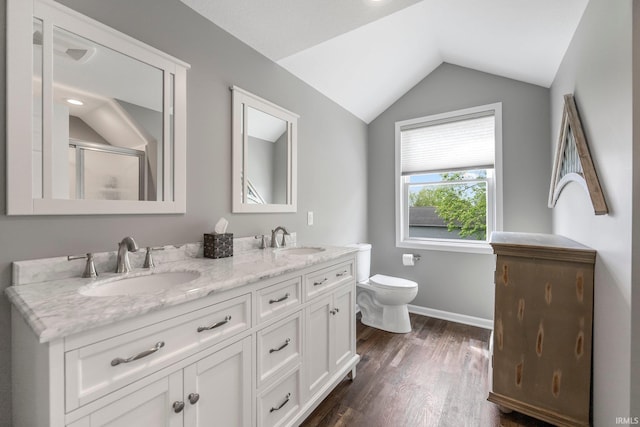full bath featuring lofted ceiling, wood finished floors, toilet, double vanity, and an enclosed shower