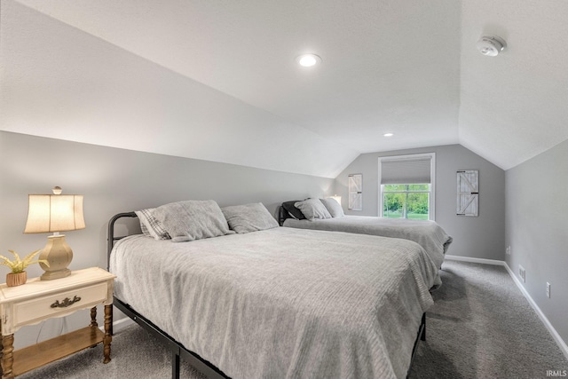 bedroom featuring baseboards, lofted ceiling, and carpet