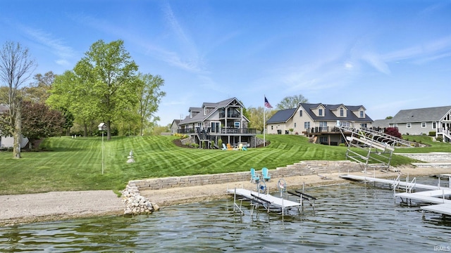 dock with a yard, a deck with water view, and stairway
