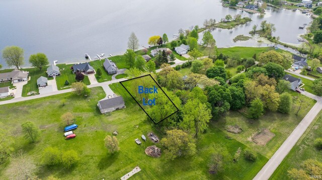 aerial view of residential area with a nearby body of water and property parcel outlined