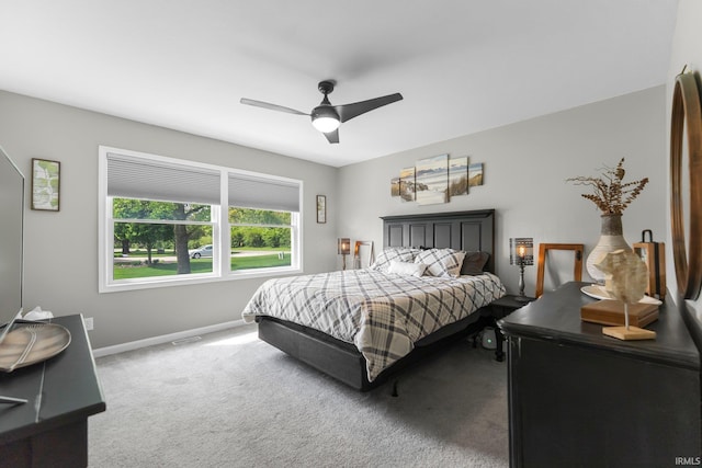 carpeted bedroom featuring baseboards and a ceiling fan