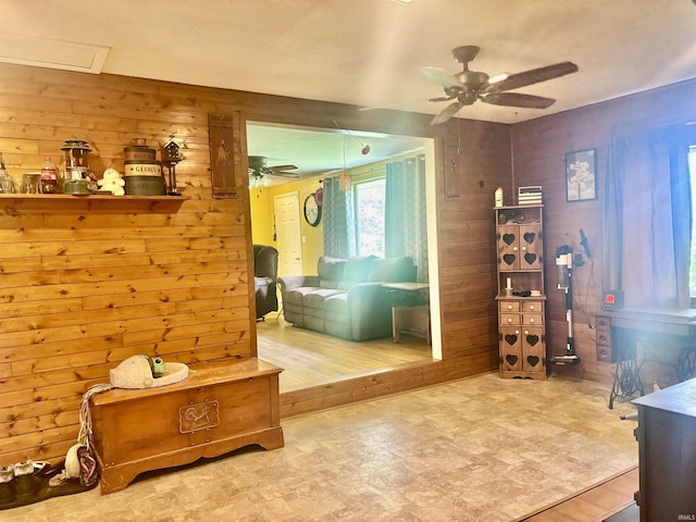 4203 Logansport Rd, Logansport, IN 46947 - bedroom featuring wooden walls, tile patterned floors, a ceiling fan, and a wood stove