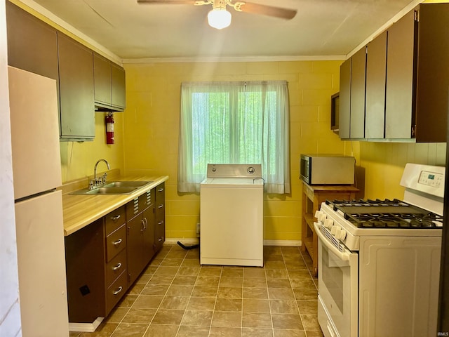 4203 Logansport Rd, Logansport, IN 46947 - kitchen featuring washer / dryer, white appliances, a sink, crown molding, and a ceiling fan