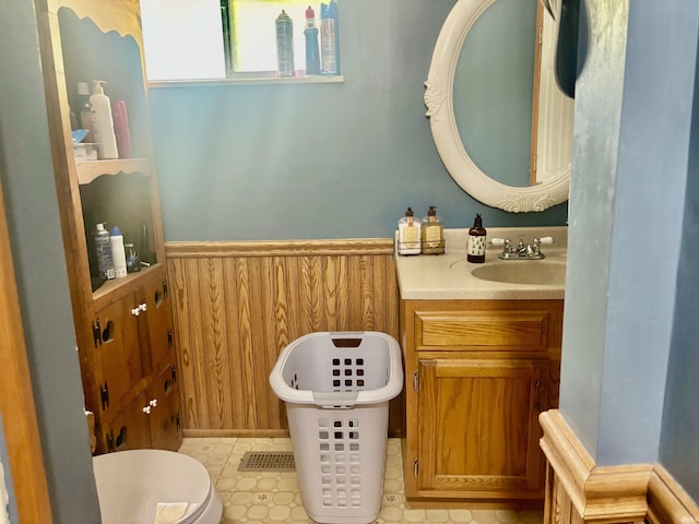 4203 Logansport Rd, Logansport, IN 46947 - bathroom featuring vanity, wainscoting, wood walls, toilet, and a soaking tub