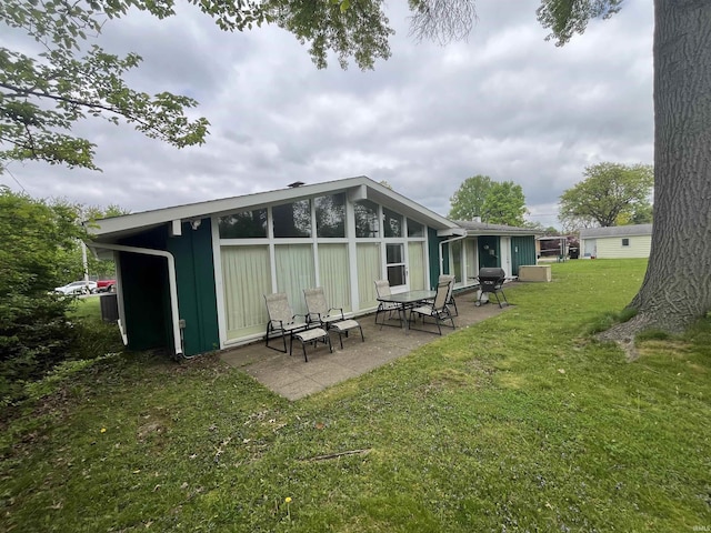 3212 S Saint Joseph St, South Bend, IN 46614 - back of house with a lawn and a patio