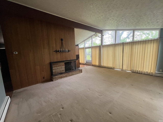 3212 S Saint Joseph St, South Bend, IN 46614 - unfurnished living room with baseboard heating, wooden walls, a brick fireplace, carpet flooring, and a textured ceiling