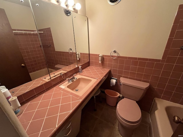 3212 S Saint Joseph St, South Bend, IN 46614 - bathroom with a sink, tile walls, tile patterned floors, toilet, and a wainscoted wall