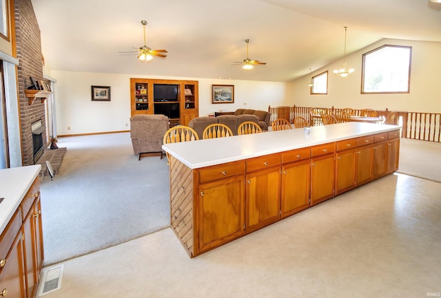 509 Mount Ashley Rd, Evansville, IN 47711 - kitchen featuring lofted ceiling, ceiling fan, a brick fireplace, light colored carpet, and open floor plan