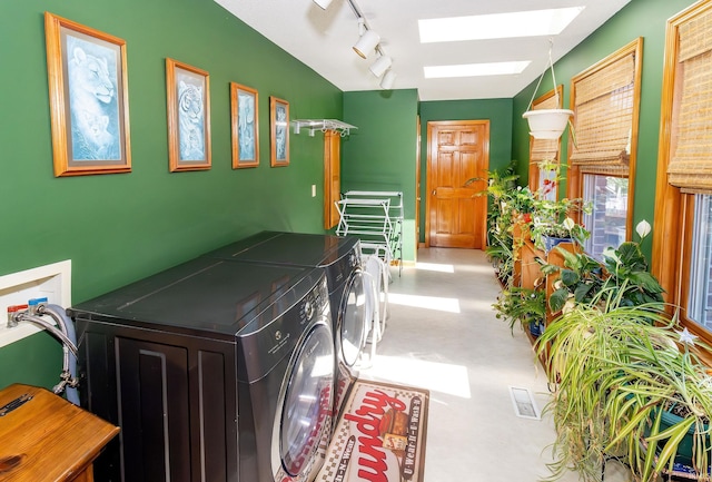 509 Mount Ashley Rd, Evansville, IN 47711 - laundry room with a skylight, washer and clothes dryer, and rail lighting