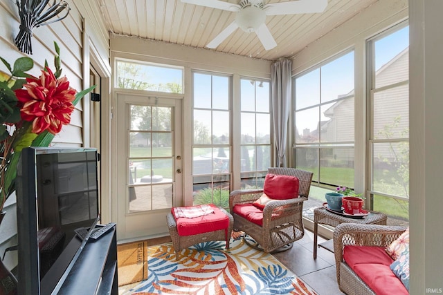 sunroom with a ceiling fan and an outdoor hangout area