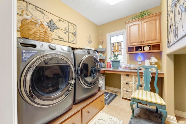 laundry area with independent washer and dryer, light tile patterned floors, a textured ceiling, cabinet space, and a desk