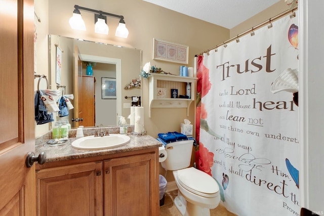 bathroom featuring toilet, vanity, and a shower with shower curtain