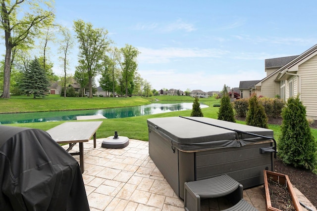 view of patio / terrace featuring a hot tub, a water view, a grill, and a residential view