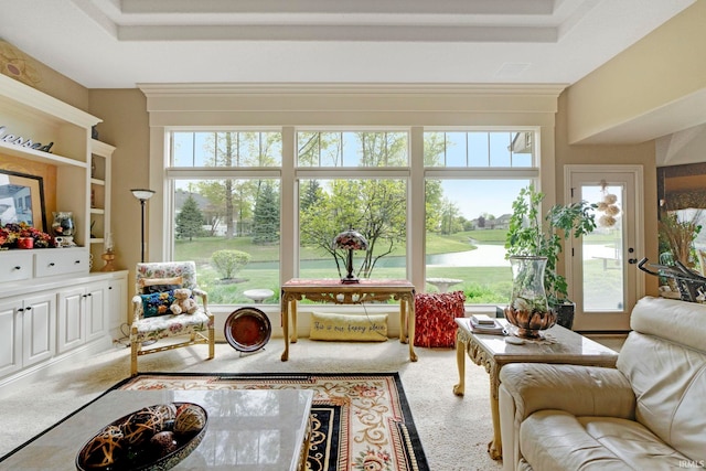 sunroom / solarium featuring a water view