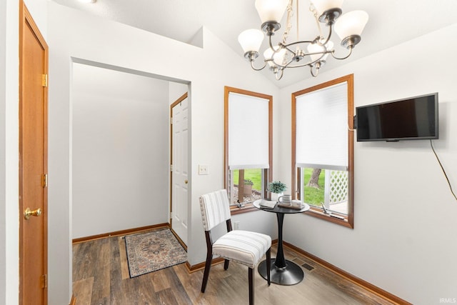 6114 Picacho Dr, Fort Wayne, IN 46825 - dining room with a chandelier, wood finished floors, baseboards, and lofted ceiling