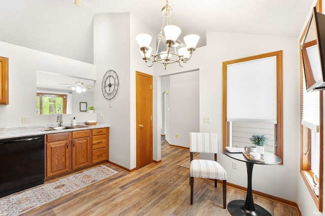 6114 Picacho Dr, Fort Wayne, IN 46825 - kitchen featuring dishwasher, a sink, lofted ceiling, light wood-style floors, and light countertops