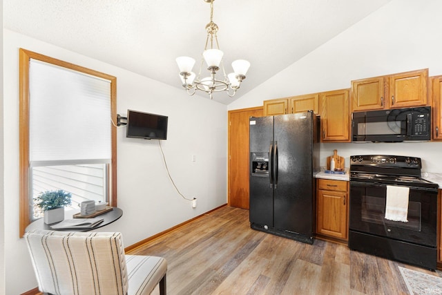 6114 Picacho Dr, Fort Wayne, IN 46825 - kitchen with black appliances, a chandelier, lofted ceiling, light wood-style flooring, and light countertops