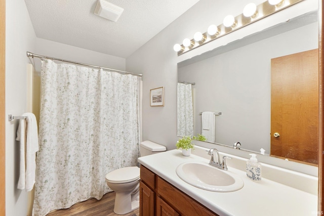 6114 Picacho Dr, Fort Wayne, IN 46825 - bathroom featuring wood finished floors, toilet, vanity, and a textured ceiling