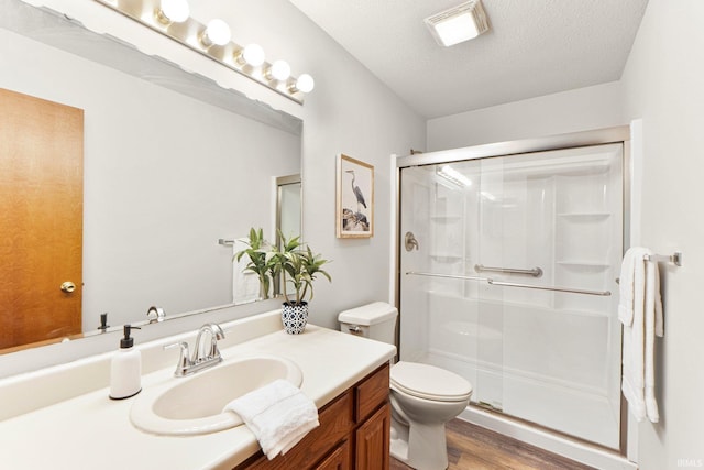 6114 Picacho Dr, Fort Wayne, IN 46825 - full bath with wood finished floors, a stall shower, toilet, vanity, and a textured ceiling