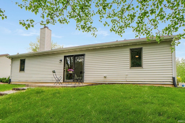 6114 Picacho Dr, Fort Wayne, IN 46825 - back of house featuring a lawn and a chimney