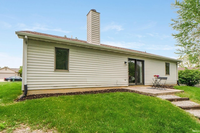 6114 Picacho Dr, Fort Wayne, IN 46825 - rear view of property featuring a yard, a chimney, and a patio