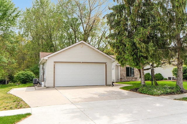 6114 Picacho Dr, Fort Wayne, IN 46825 - view of front facade featuring central air condition unit, driveway, a front yard, and an attached garage