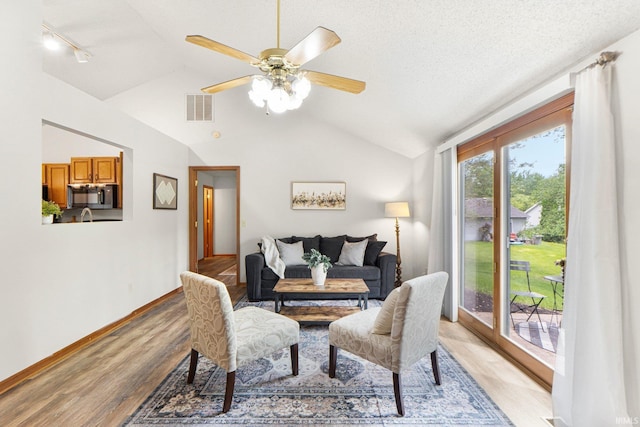 6114 Picacho Dr, Fort Wayne, IN 46825 - dining space featuring vaulted ceiling, light wood-type flooring, track lighting, a ceiling fan, and baseboards