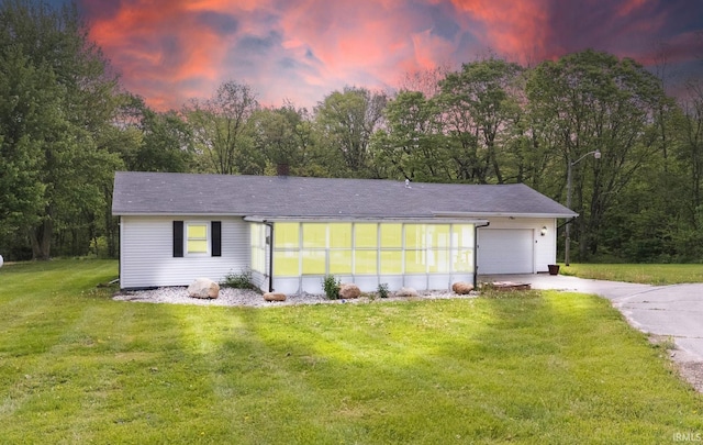 260 N 850 W-92 Rd, Pierceton, IN 46562 - view of front of house featuring driveway, a garage, a sunroom, and a yard