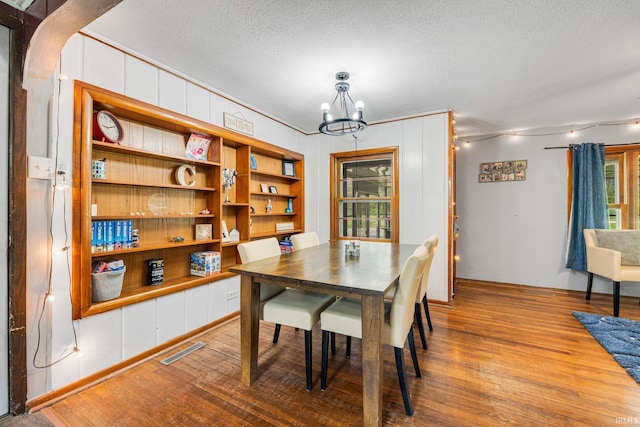 260 N 850 W-92 Rd, Pierceton, IN 46562 - dining room with a chandelier, wood finished floors, a textured ceiling, healthy amount of natural light, and baseboards