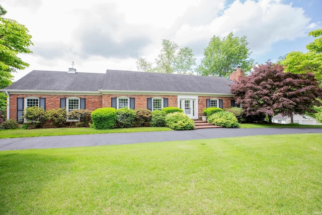 300 Springhaven Dr, Evansville, IN 47710 - single story home with a chimney, brick siding, a front lawn, and a shingled roof
