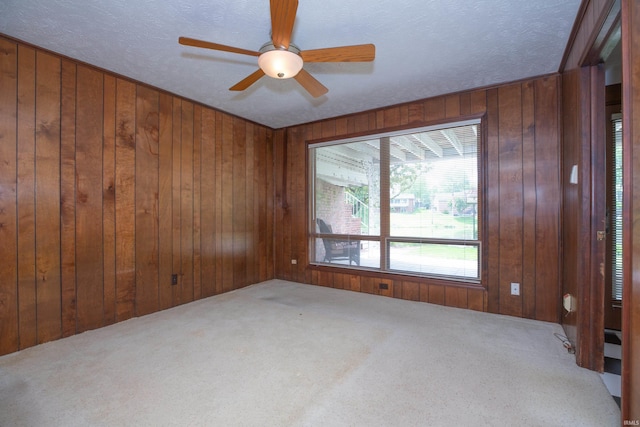 300 Springhaven Dr, Evansville, IN 47710 - carpeted empty room featuring wooden walls and a ceiling fan