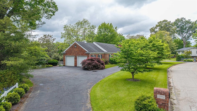 300 Springhaven Dr, Evansville, IN 47710 - view of front of property with brick siding, a garage, a front yard, and driveway