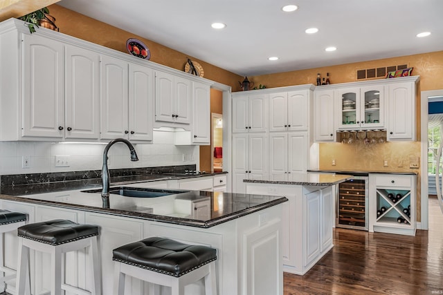 10528 Indian Ridge Dr, Fort Wayne, IN 46814 - kitchen featuring beverage cooler, a sink, a peninsula, white cabinets, and recessed lighting