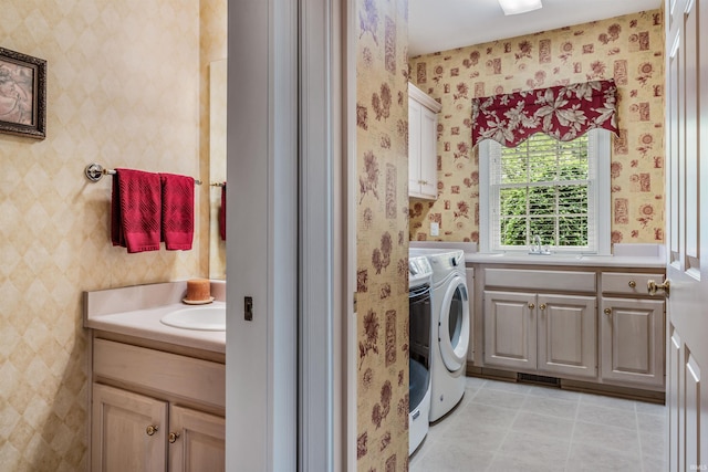 10528 Indian Ridge Dr, Fort Wayne, IN 46814 - laundry area featuring cabinet space, washer and dryer, wallpapered walls, and light tile patterned floors