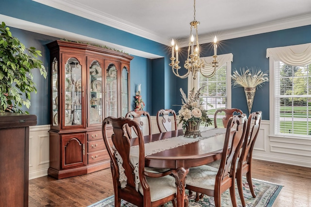 10528 Indian Ridge Dr, Fort Wayne, IN 46814 - dining room featuring a chandelier, wainscoting, wood finished floors, ornamental molding, and a decorative wall