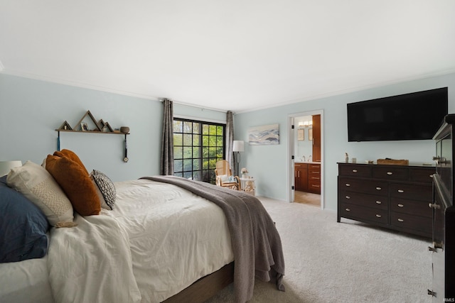 bedroom featuring light carpet and ensuite bath