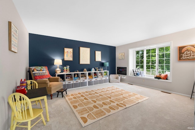 sitting room featuring carpet floors and baseboards