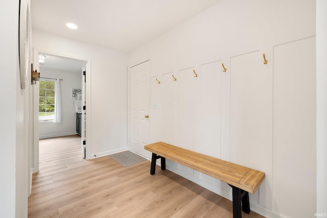 mudroom with light wood-style floors, baseboards, and recessed lighting