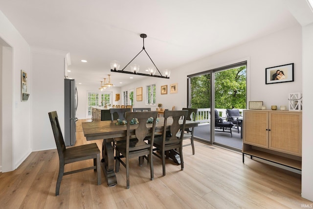 dining space featuring light wood-style flooring, a chandelier, and recessed lighting