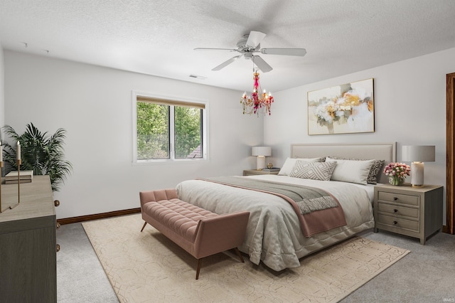 bedroom featuring light carpet, a ceiling fan, a textured ceiling, and baseboards